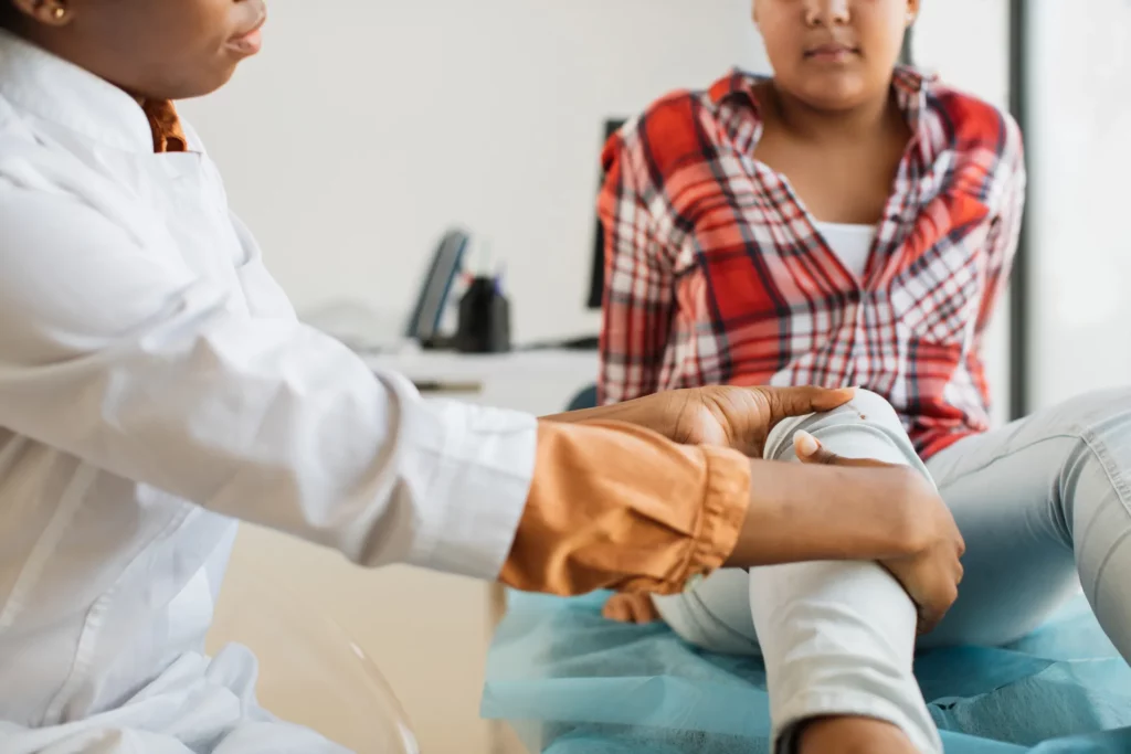 close up of afro woman doctor examining patient wi 2021 09 04 09 08 22 utc